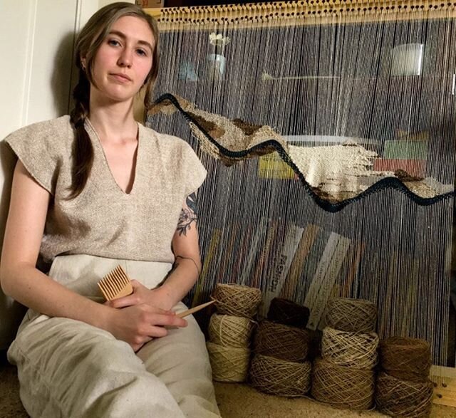 student posing in front of her weaving project