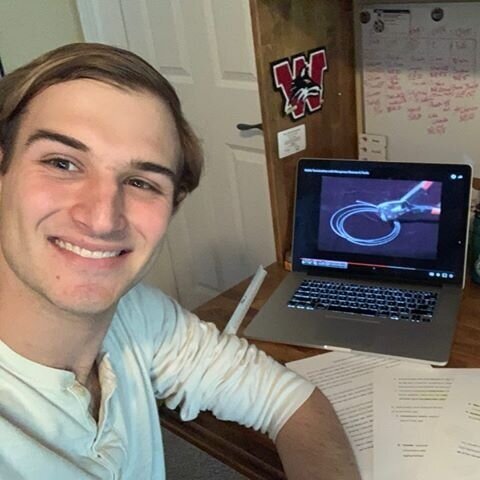 student in front of his at home desk