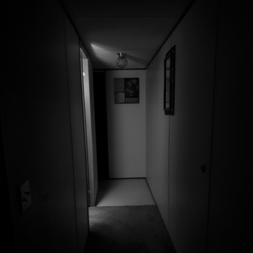 black and white photo of an empty house hallway