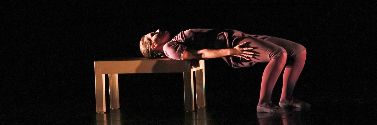 dancer laying on a bench