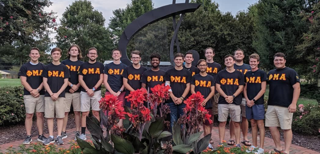Phi Mu Alpha Sigma Beta students outside robinson hall wearing their greek letters shirts