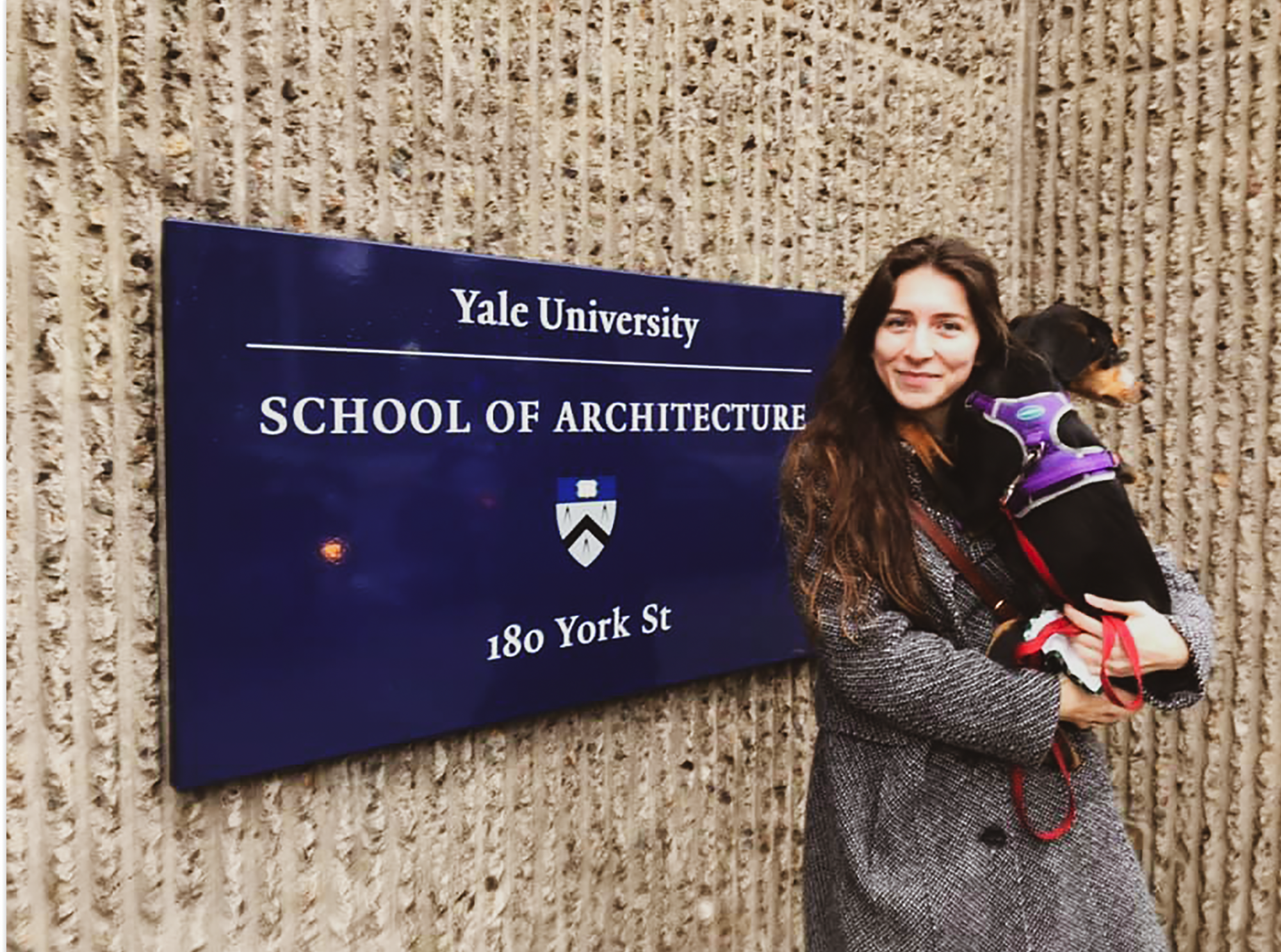 standing in front of the yale sign