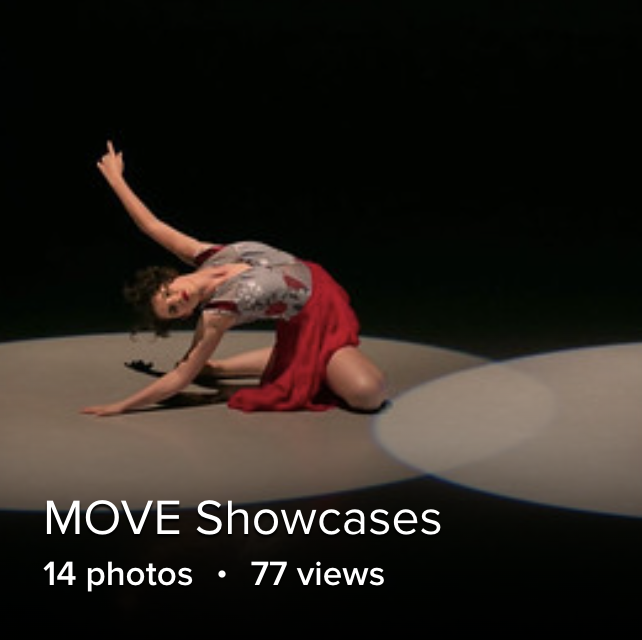 solo shot of a dancer in a red skirt sitting on the floor, reaching up in a spotlight