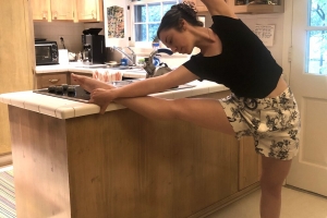 student stretching in kitchen