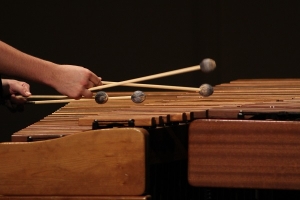 hands with mallets playing marimba