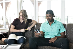screen shot from video - two students on couch