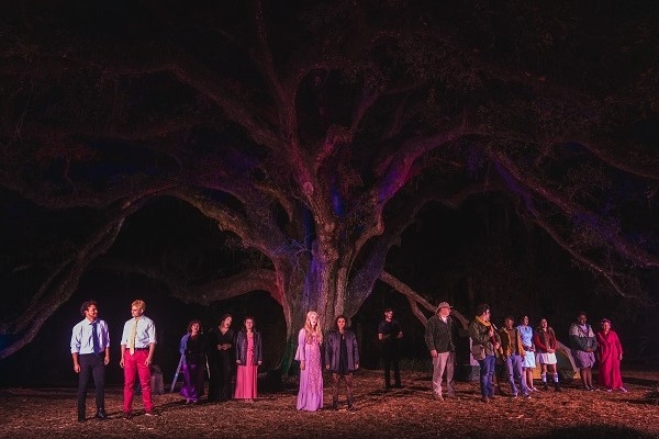 cast of Into the Woods in front of a giant oak tree.