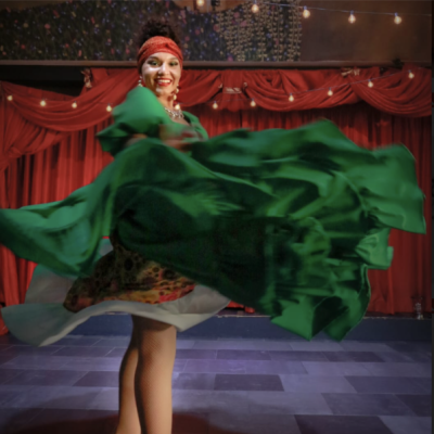 Laura dancing in a green dress