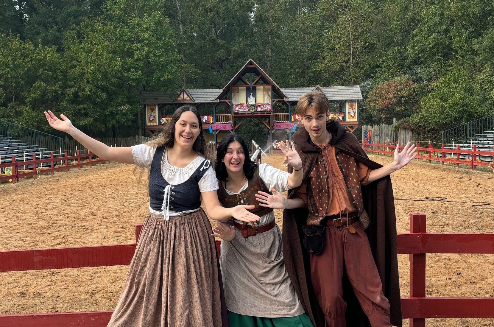 Three theatre students in commedia costumes at the Renaissance Festival