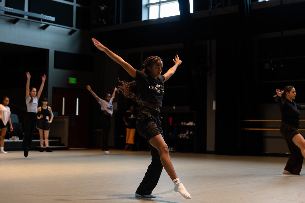 Dance student going across the floor with hands outstretched