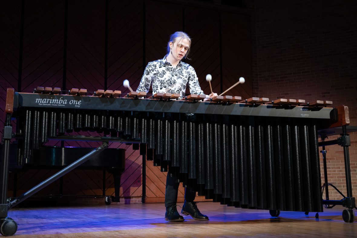 Music student on stage performing on a marimba
