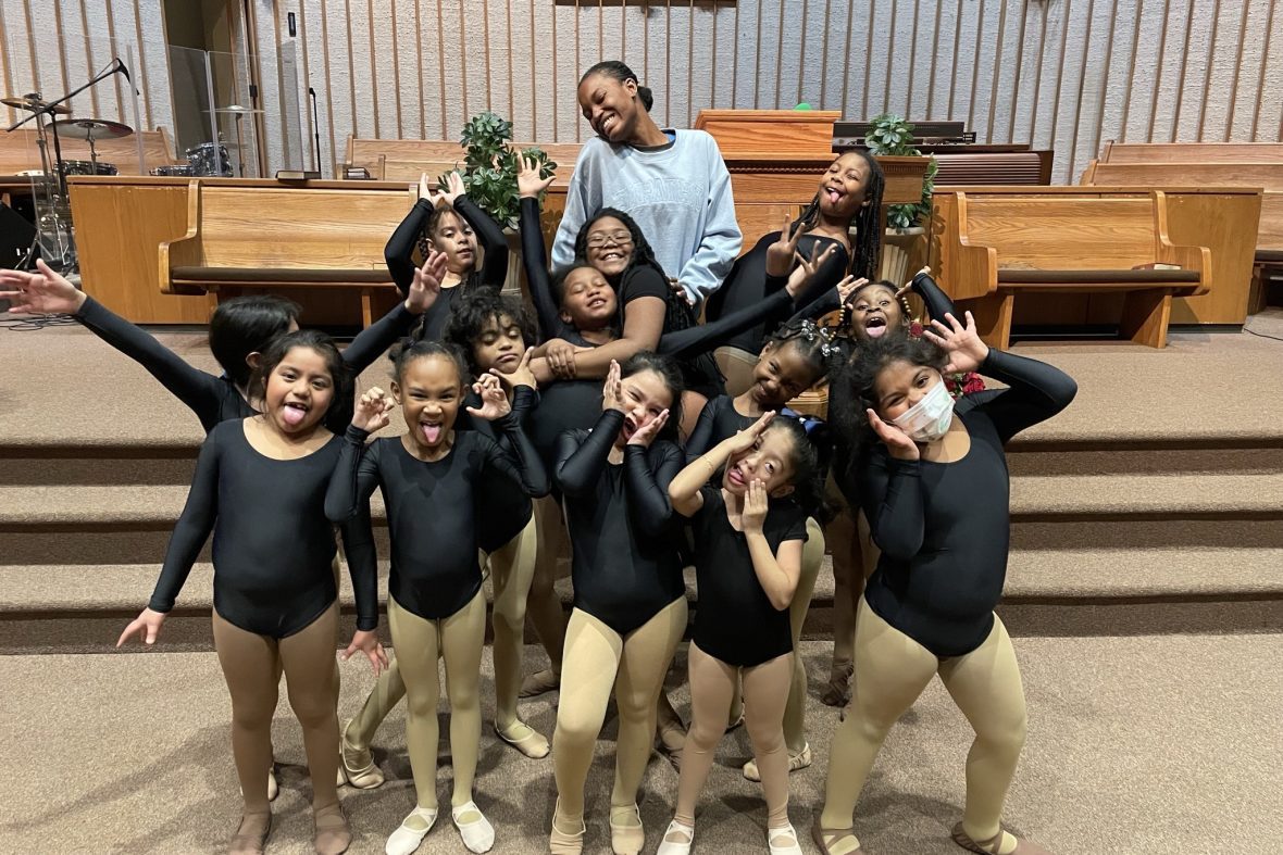 dance students in a community center with a group of young dancers making silly faces