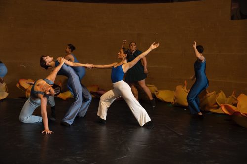 Dancers in a performance wearing blue costumes