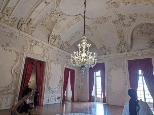 Photo of a museum, empty room with beautiful architectural details and chandelier