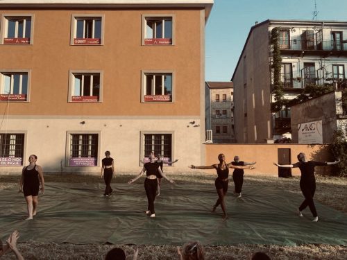 dance students performing outside in a field