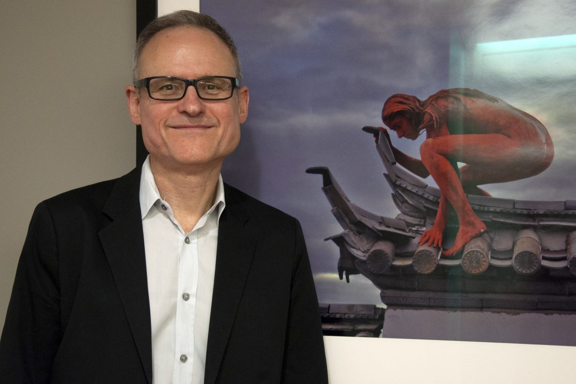 man posing in front of photo