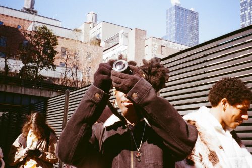 student holding up her camera