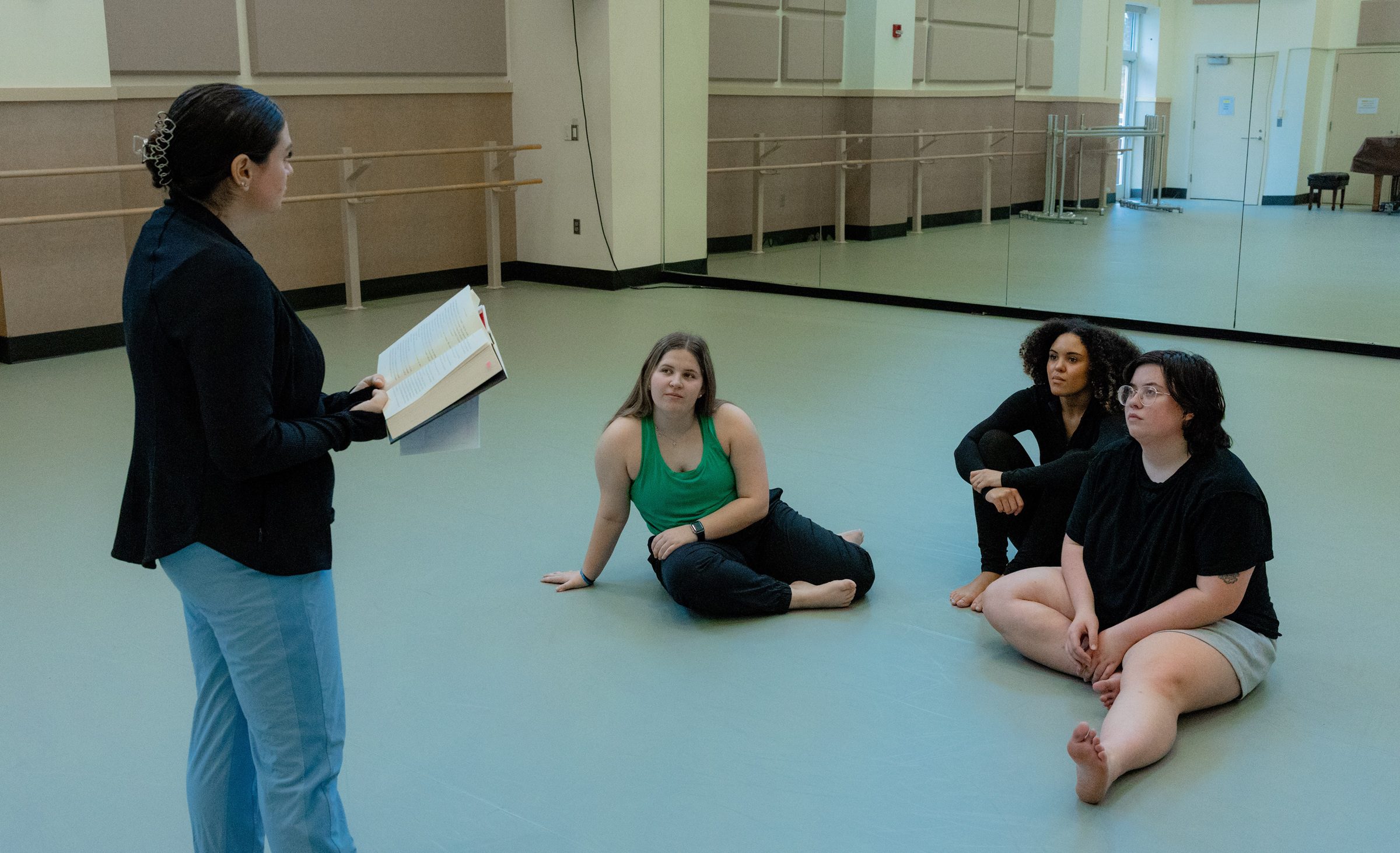 Chloe Gosline leading a book discussion with dance education students.