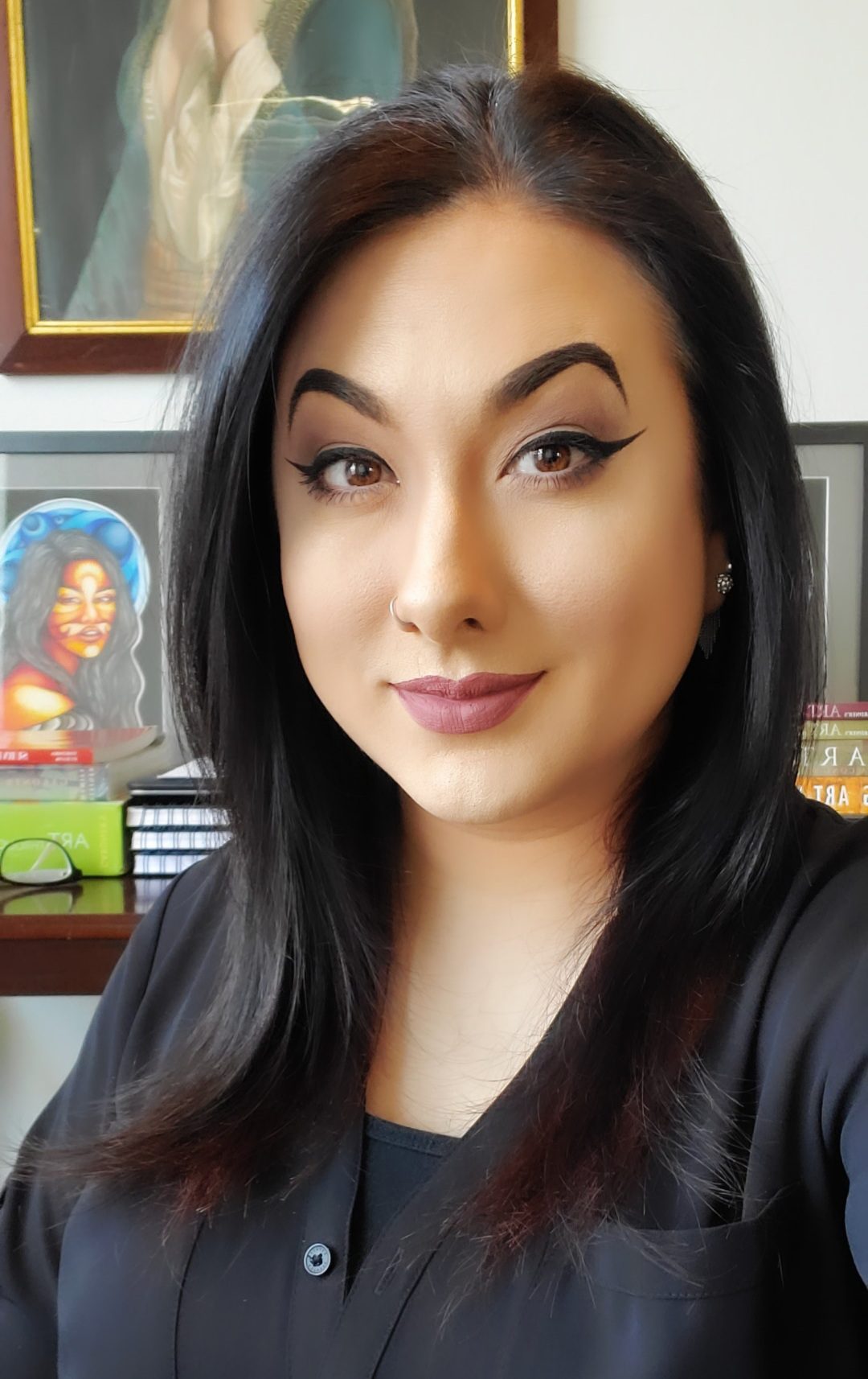 Sydney Sheaffer headshot with art in the background