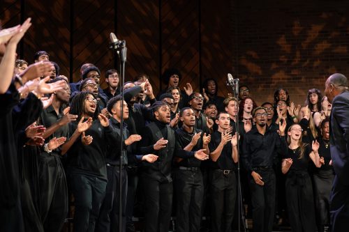 Group of students clapping on stage in Gospel Choir