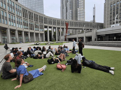 students sitting on the grass 