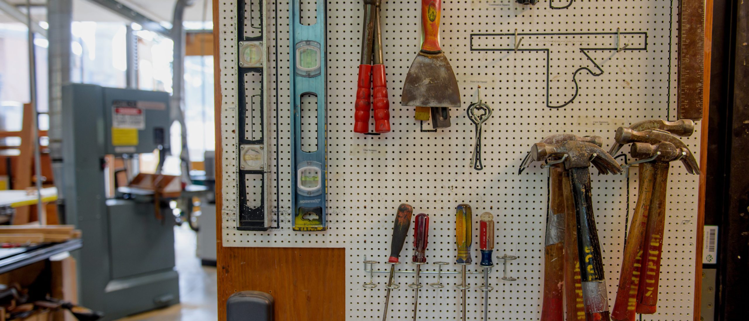 Close-up of tools hanging on the wall in the studio