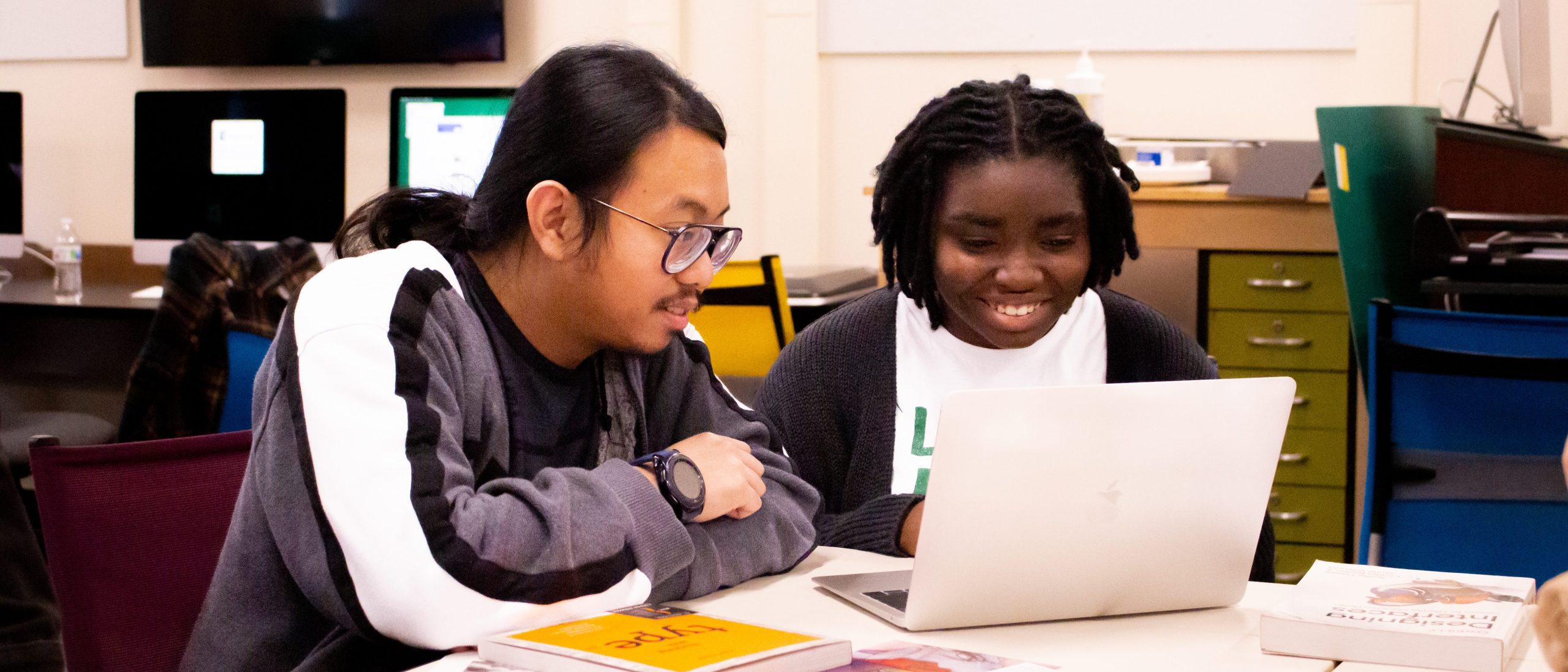 Two students looking at a computer