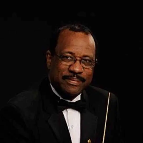 headshot of guest artist in a black suit and bowtie