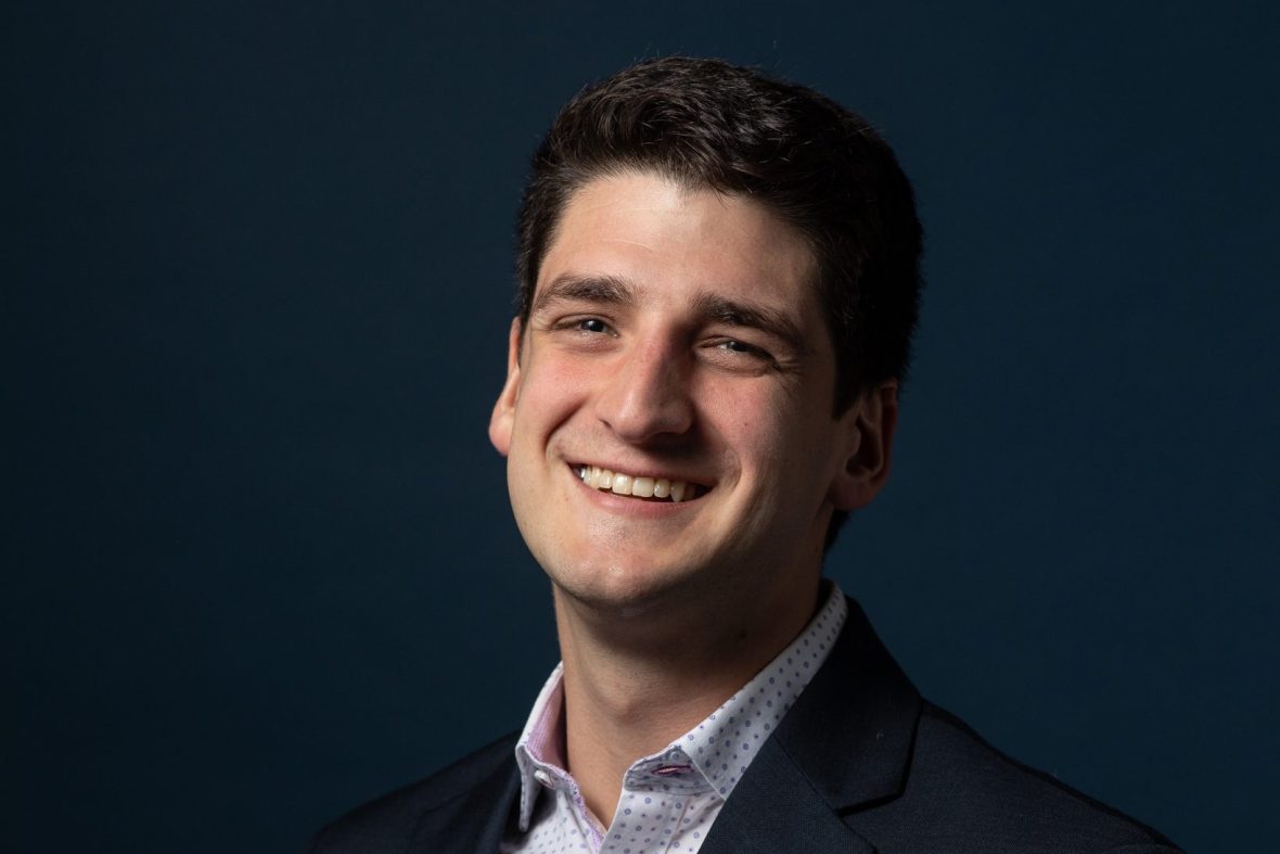 Headshot of Brian Taylor on a blue background