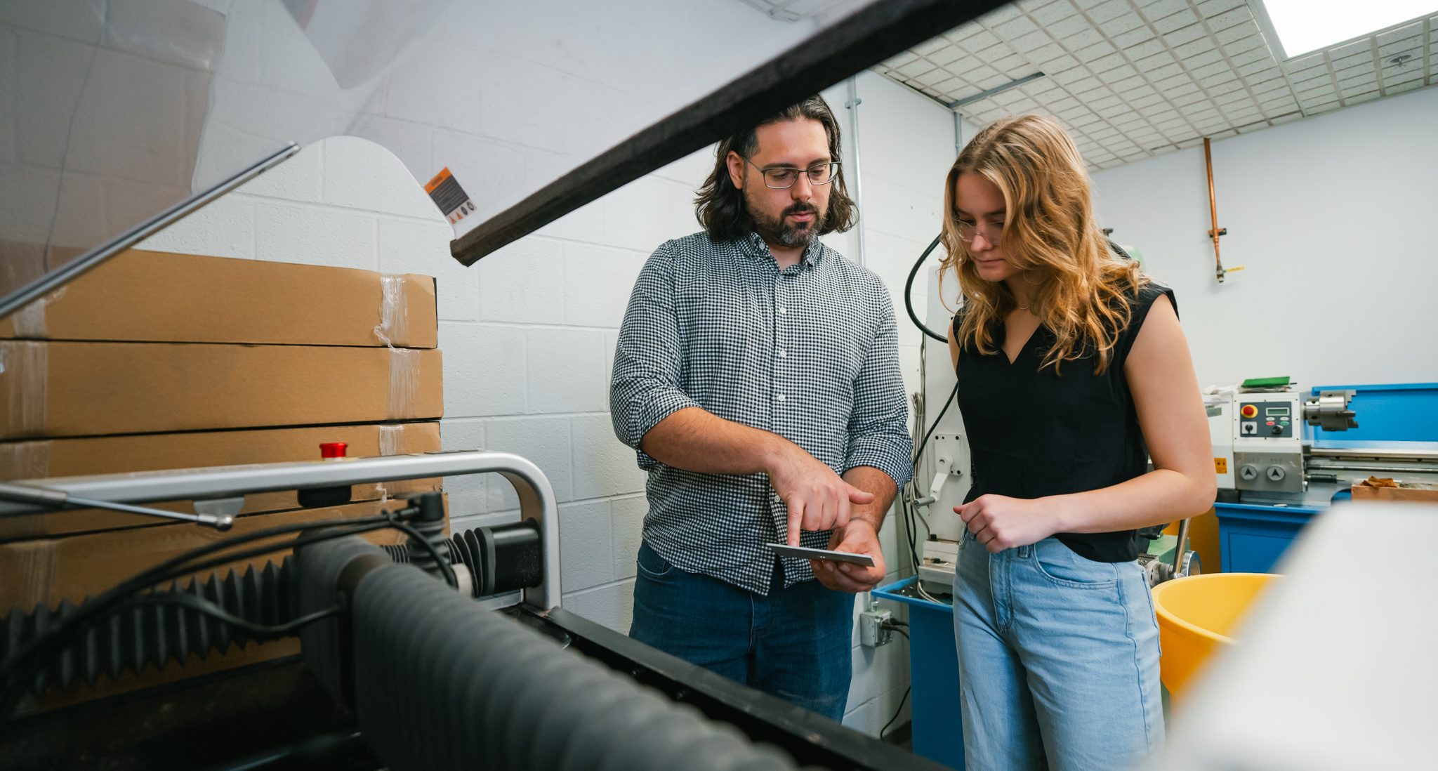 student working with professor in the lab with glasses on
