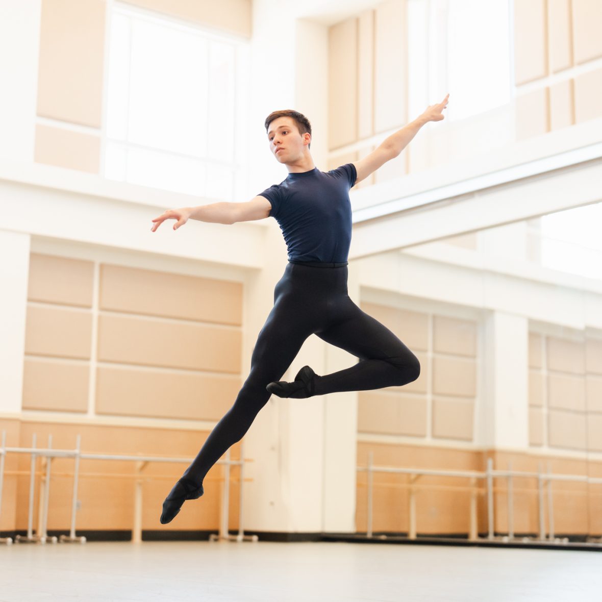 Male ballet student in the studio jumping