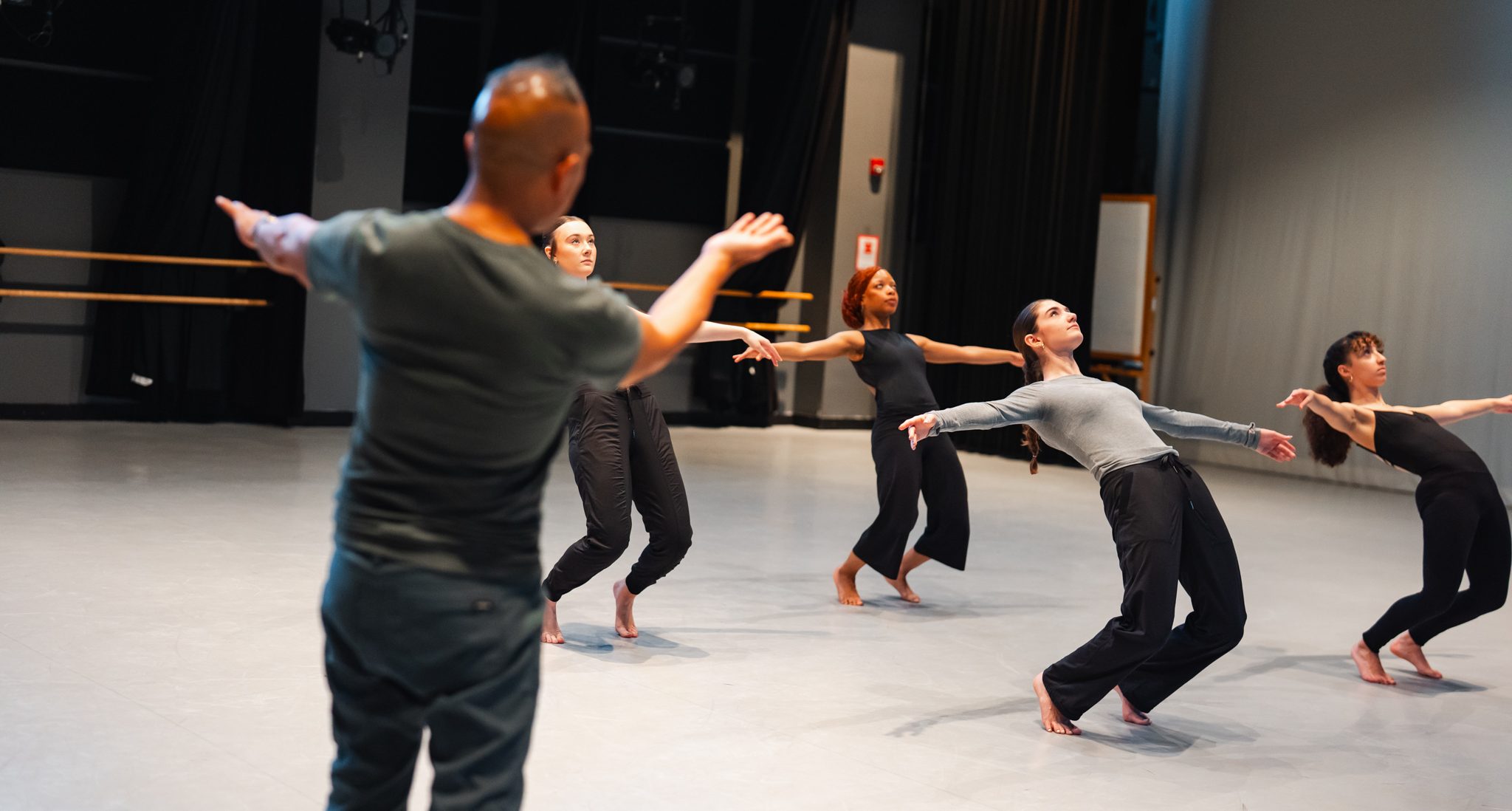 Dancers in a hinge in the studio being coached by professor