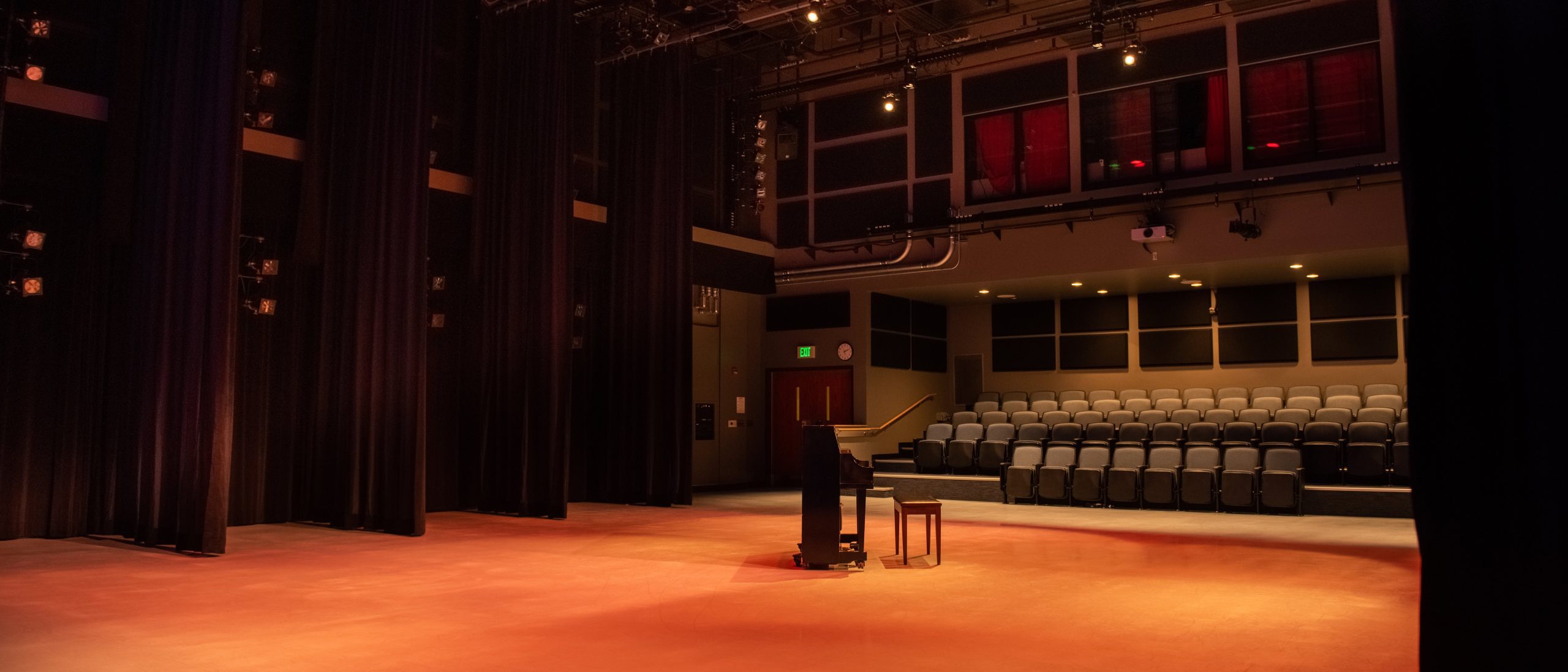 Empty studio set up as performance space with piano and center