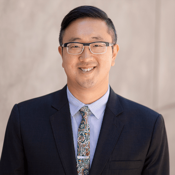 Headshot of guest clinician in a blue suit