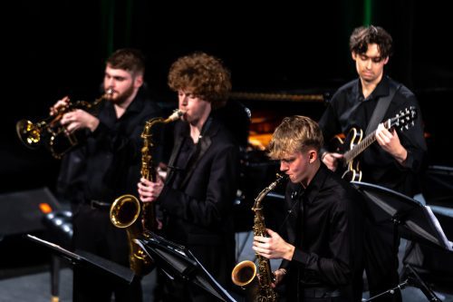 Four jazz students playing on stage