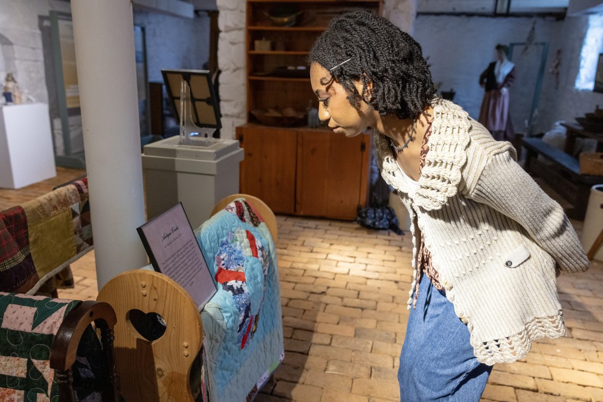 woman looking at description in historical museum setting
