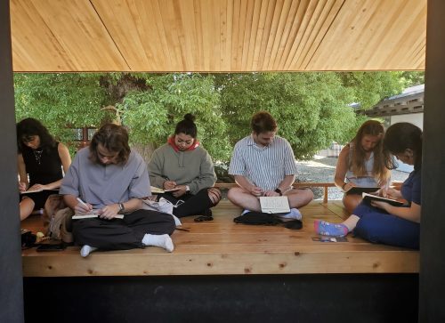 students with notebooks outside