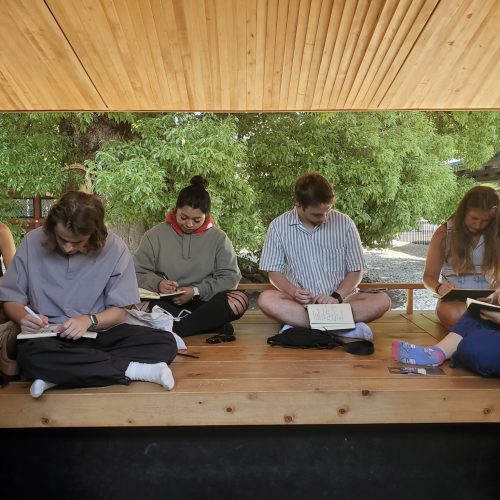 students with notebooks outside