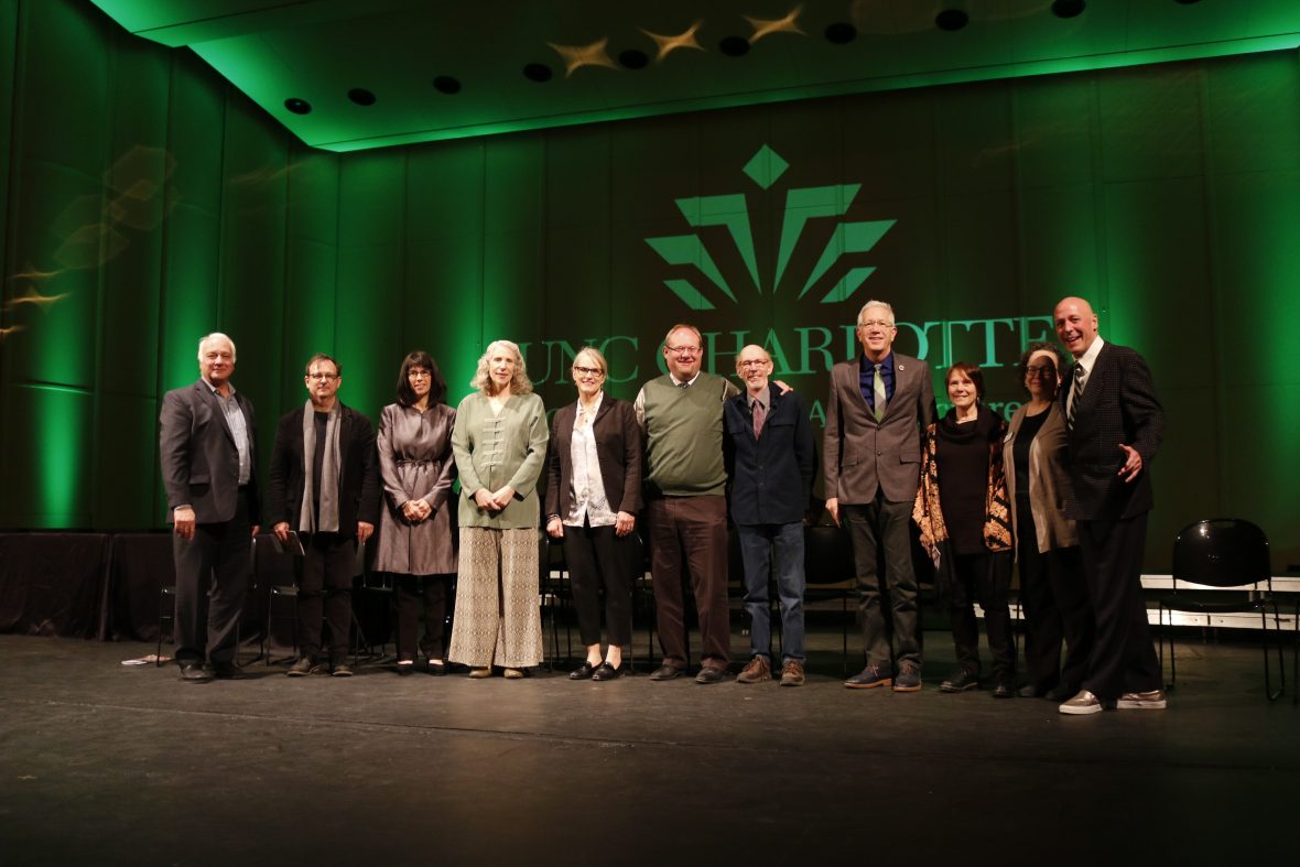 green lite stage with alumni standing