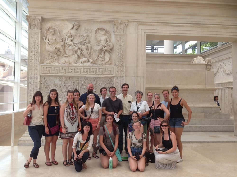 Faculty and students inside a museum