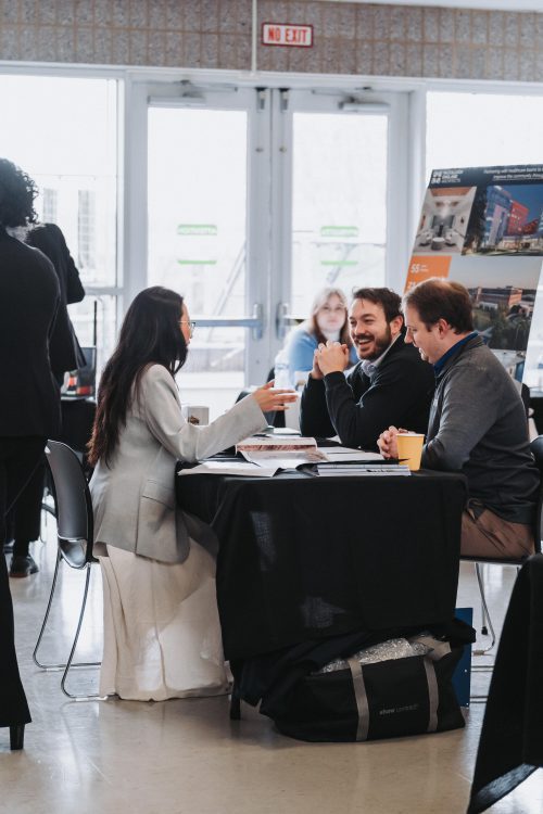 people discussing at a booth