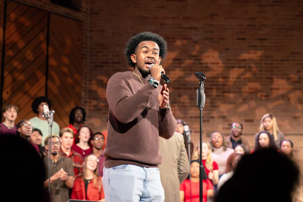 Music minor on stage singing as part of Gospel Choir performance