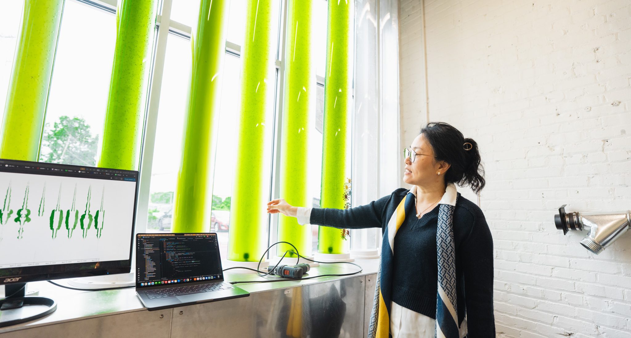 Professor Kyoung Hee Kim demonstrating her algae window installation project