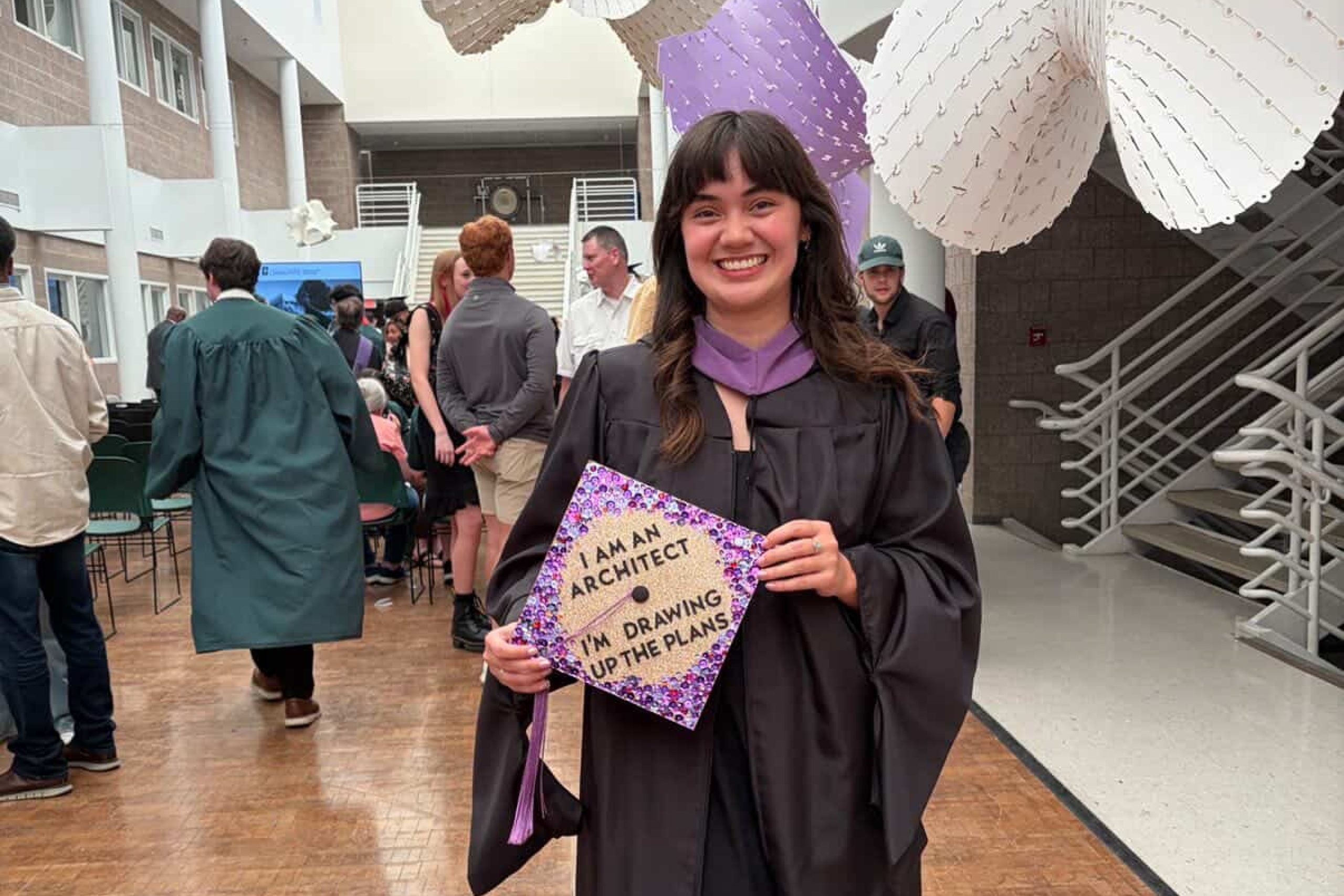 Sam in her graduation cap and gown in Storrs Hall