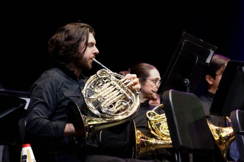Student playing French Horn