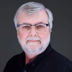 headshot of Glenn Rawls, white man with gray hair and glasses