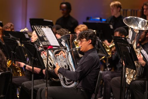 Close up of male student playing tuba in the symphonic band