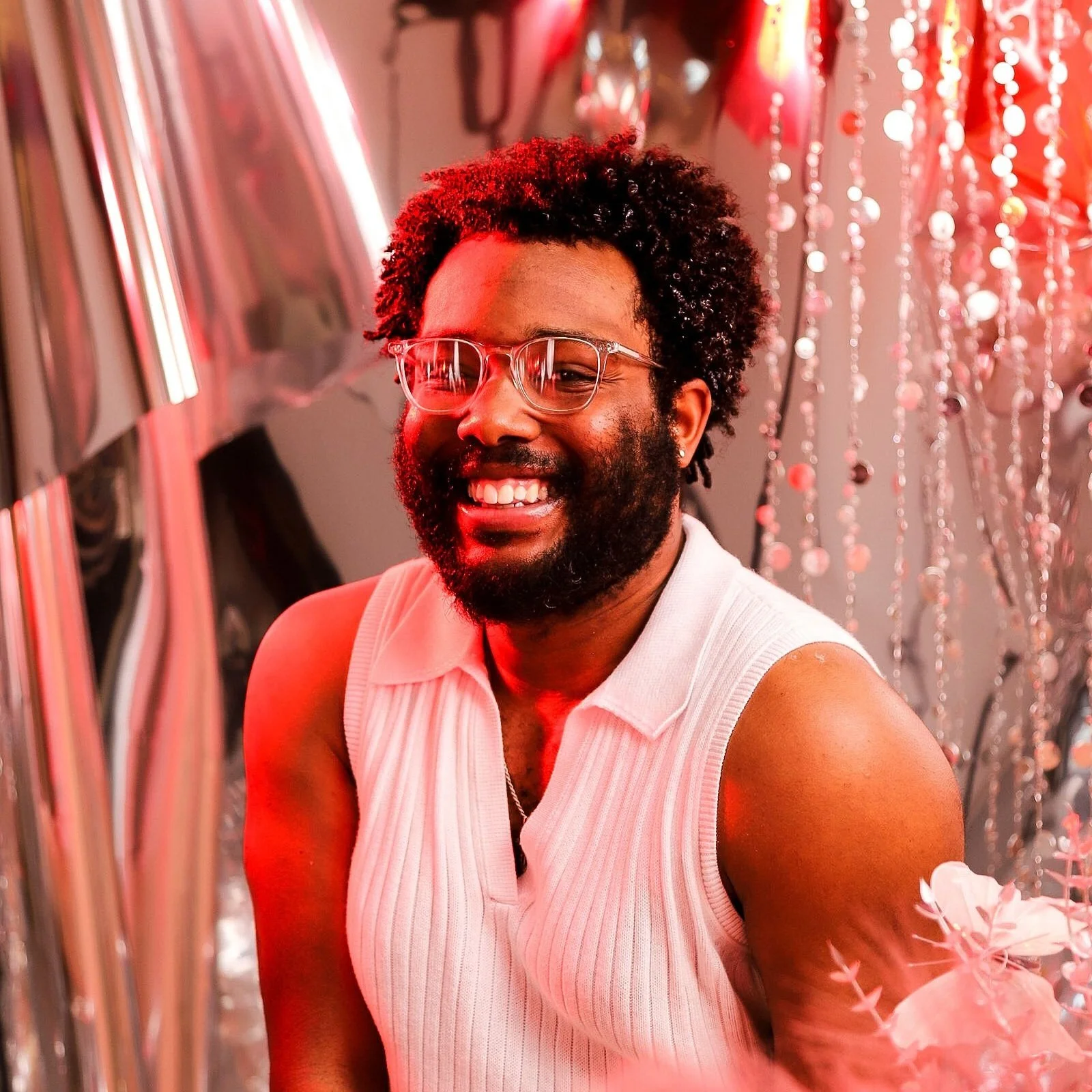 Headshot of T.J.L (T.J. Lewis) with pink lighting