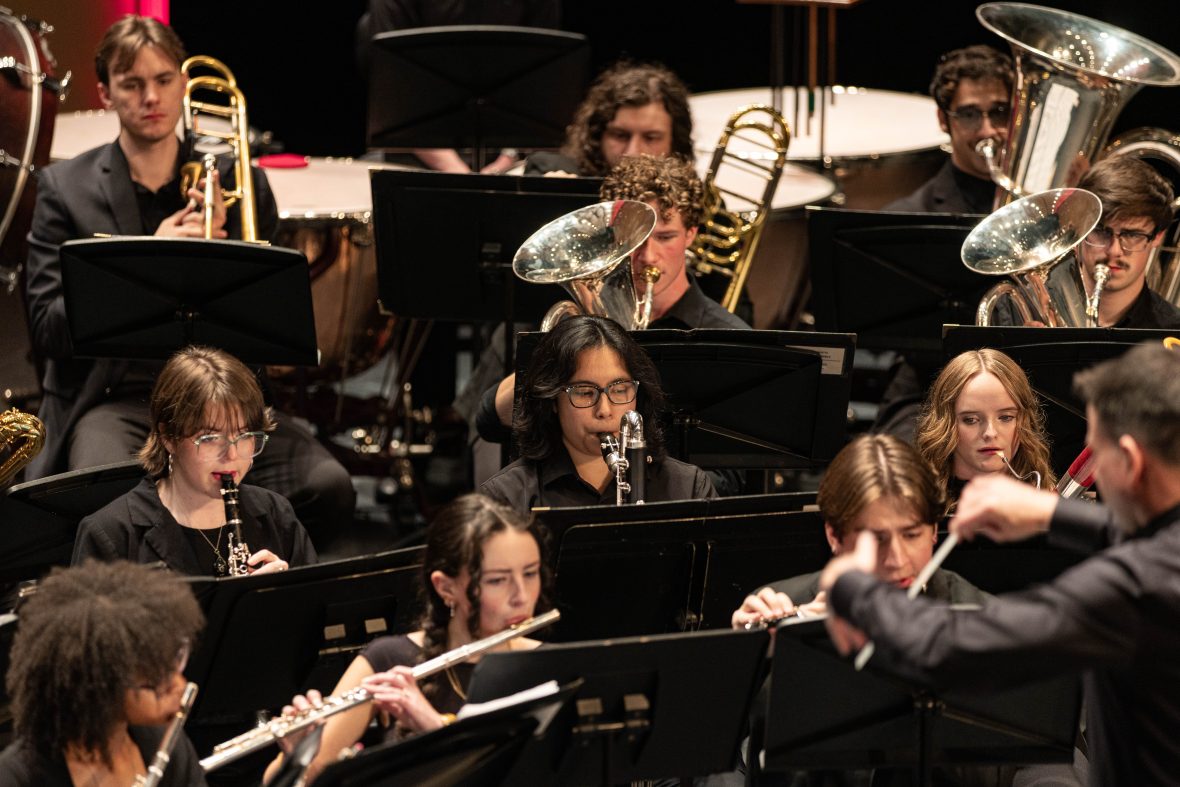 section of the wind ensemble with students playing flutes