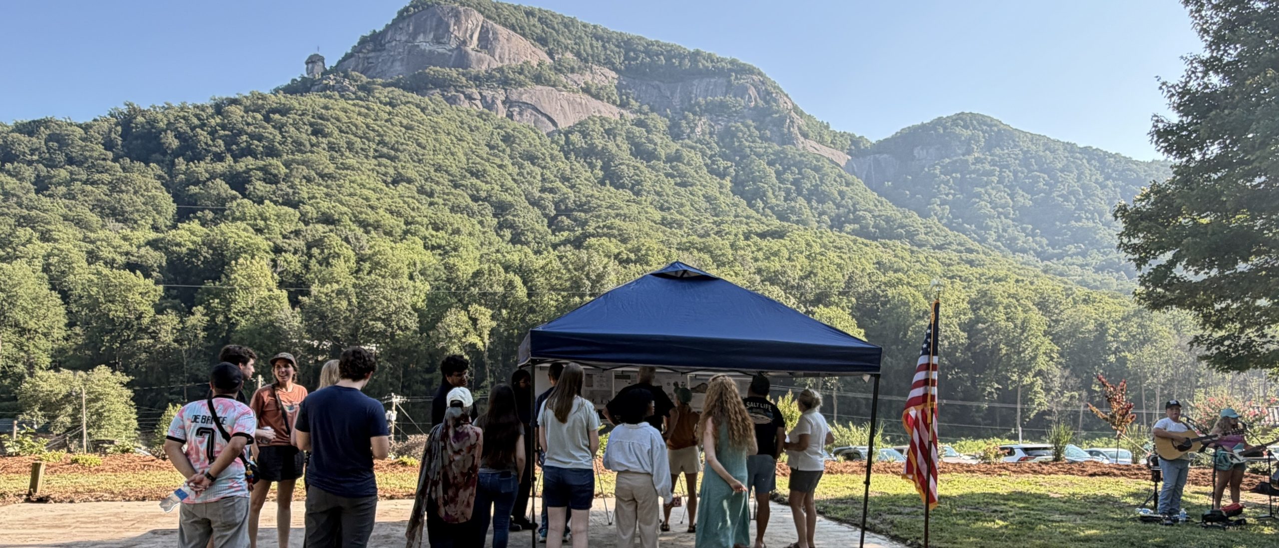 People lined up at tent below Chimney Rock to look at memorial proposals